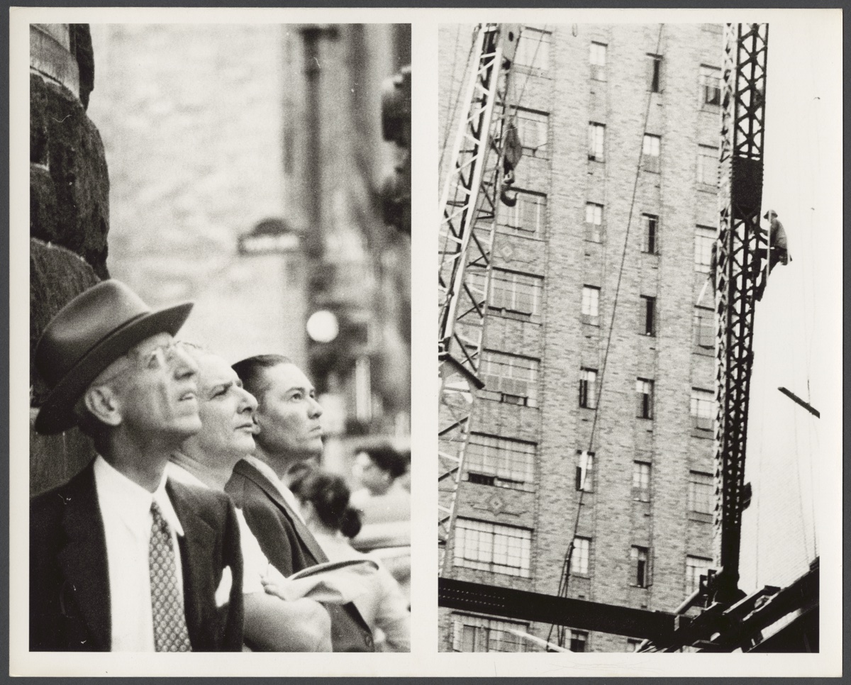 Construction workers climbing dam scaffolding while onlookers watch, 1930s