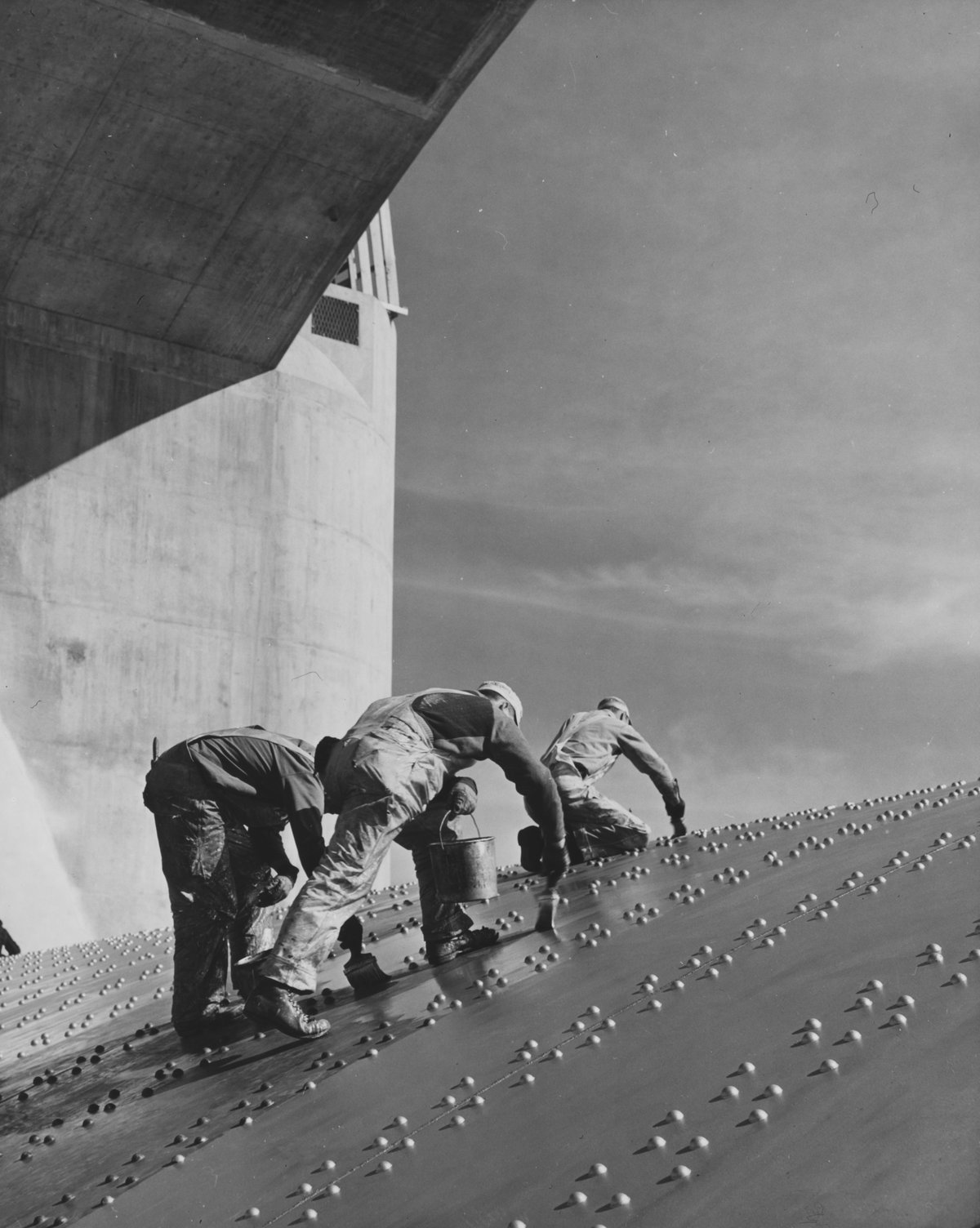 Construction workers painting the Hoover Dam spillway, 1930s